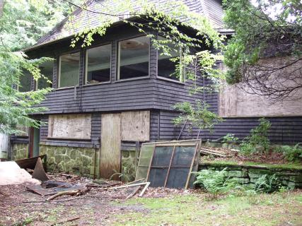 The left-most door is the door to the showers, at the base of the main house