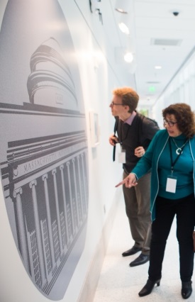 People looking at a blown-up image of the wafer on a wall