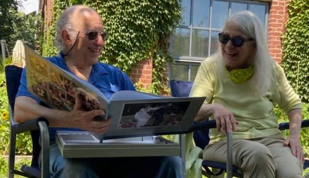 Larry and Margie reading the commemorative book